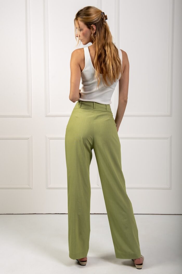 Green wide-leg pants with wide legs and a white top.